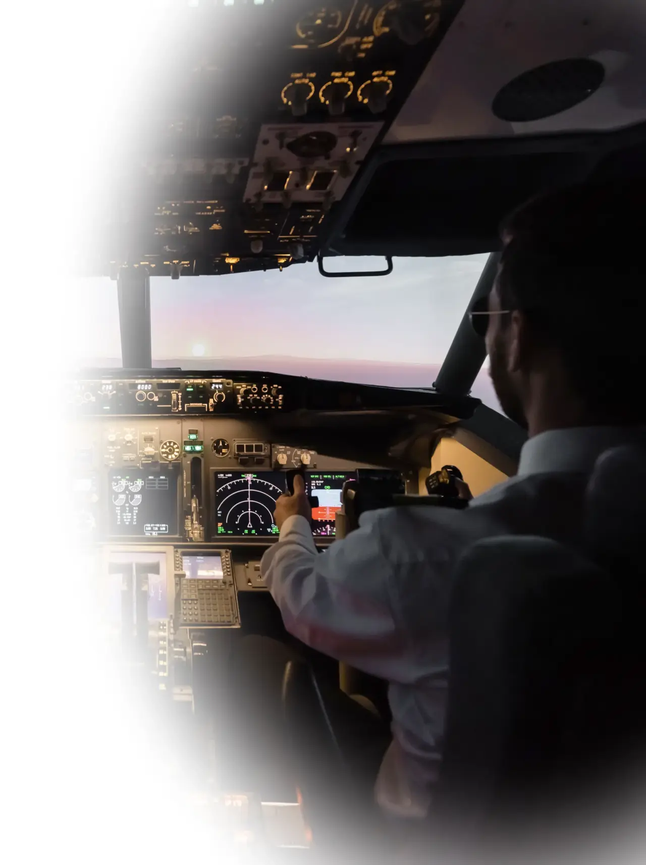 Pilots at the controls of an airliner at sunrise